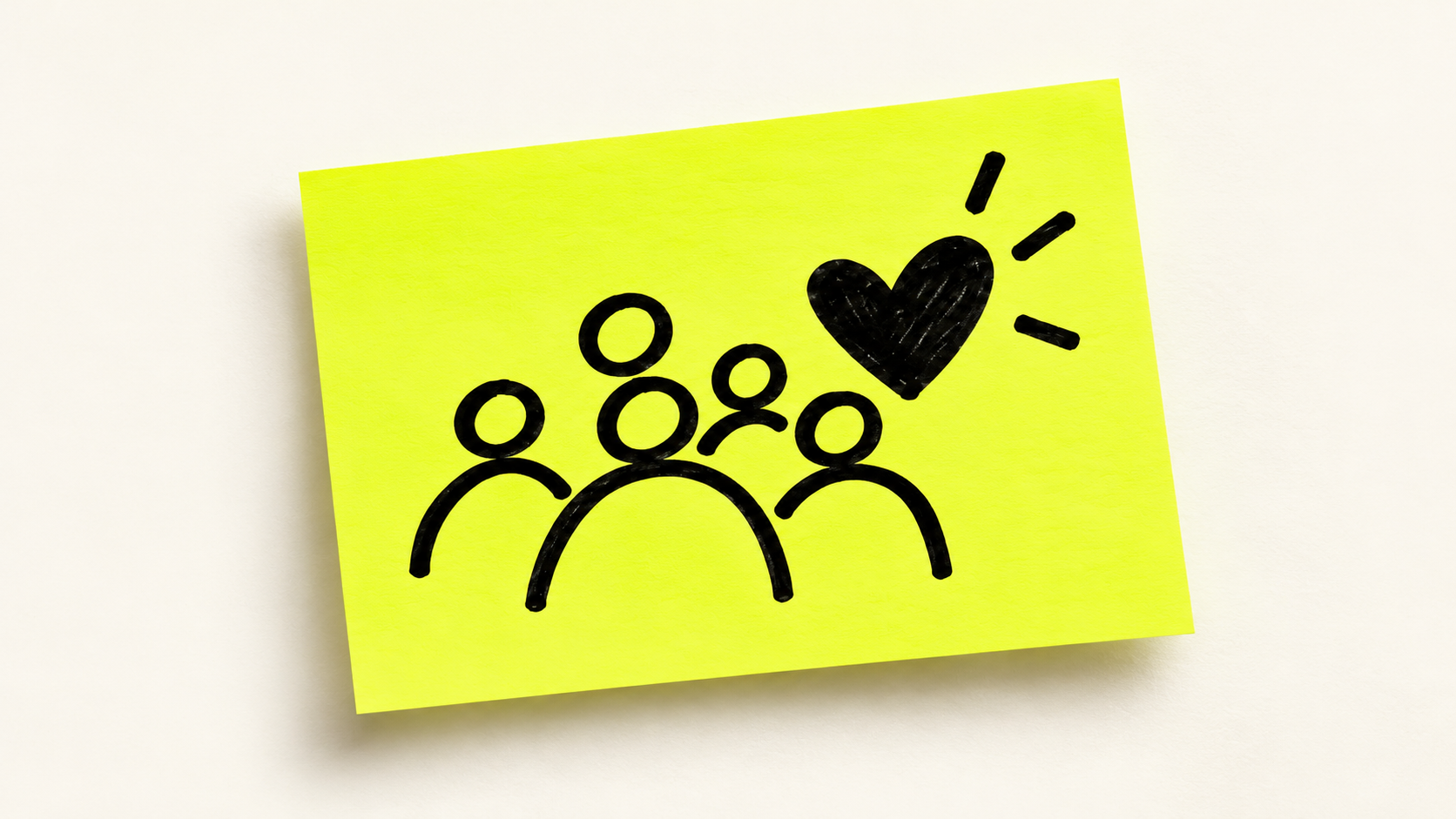 Black marker drawing on a neon sticky note of four people gathered beneath a heart